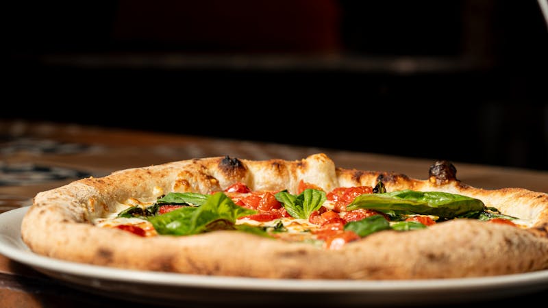 Neon Dreams pizza factory signature pizza with roasted peppers